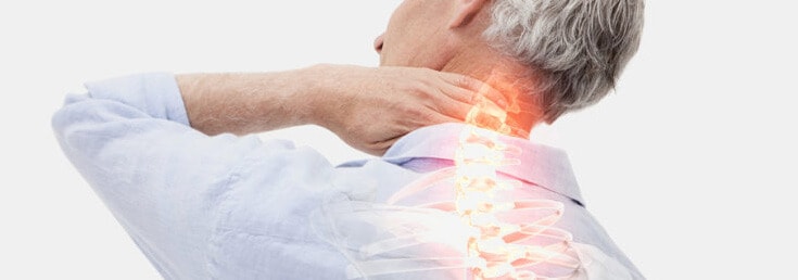 man gripping back of neck with x-ray of highlighted spine