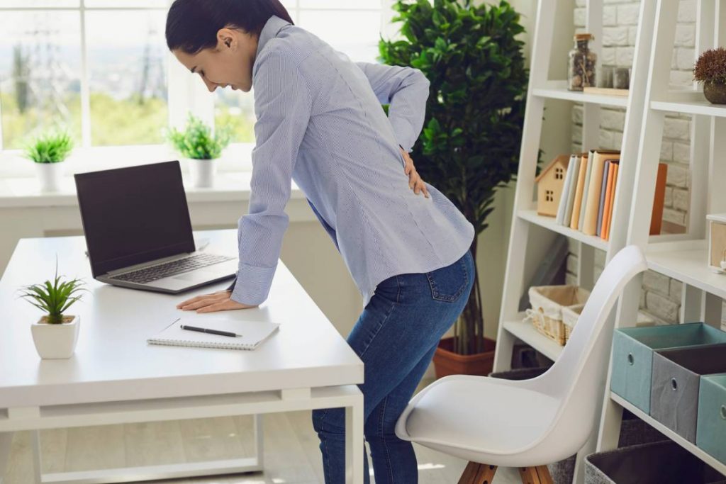Woman standing and wondering if sciatica is curable