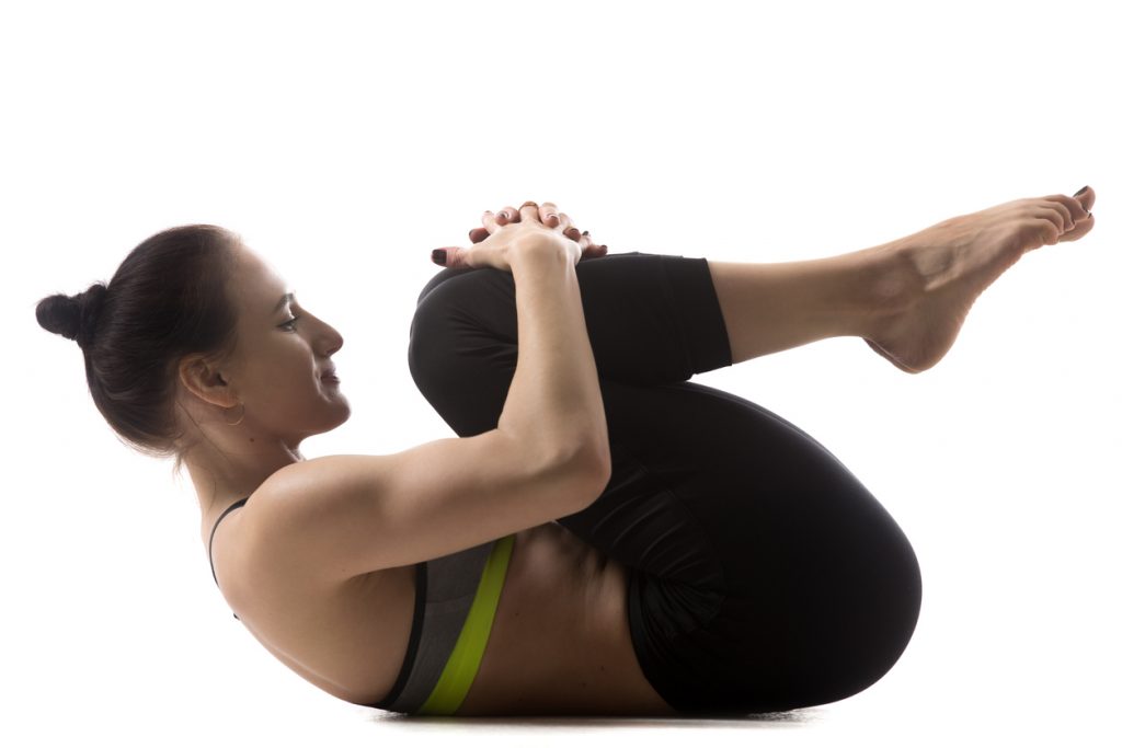 Woman stretching to help lower back pain.